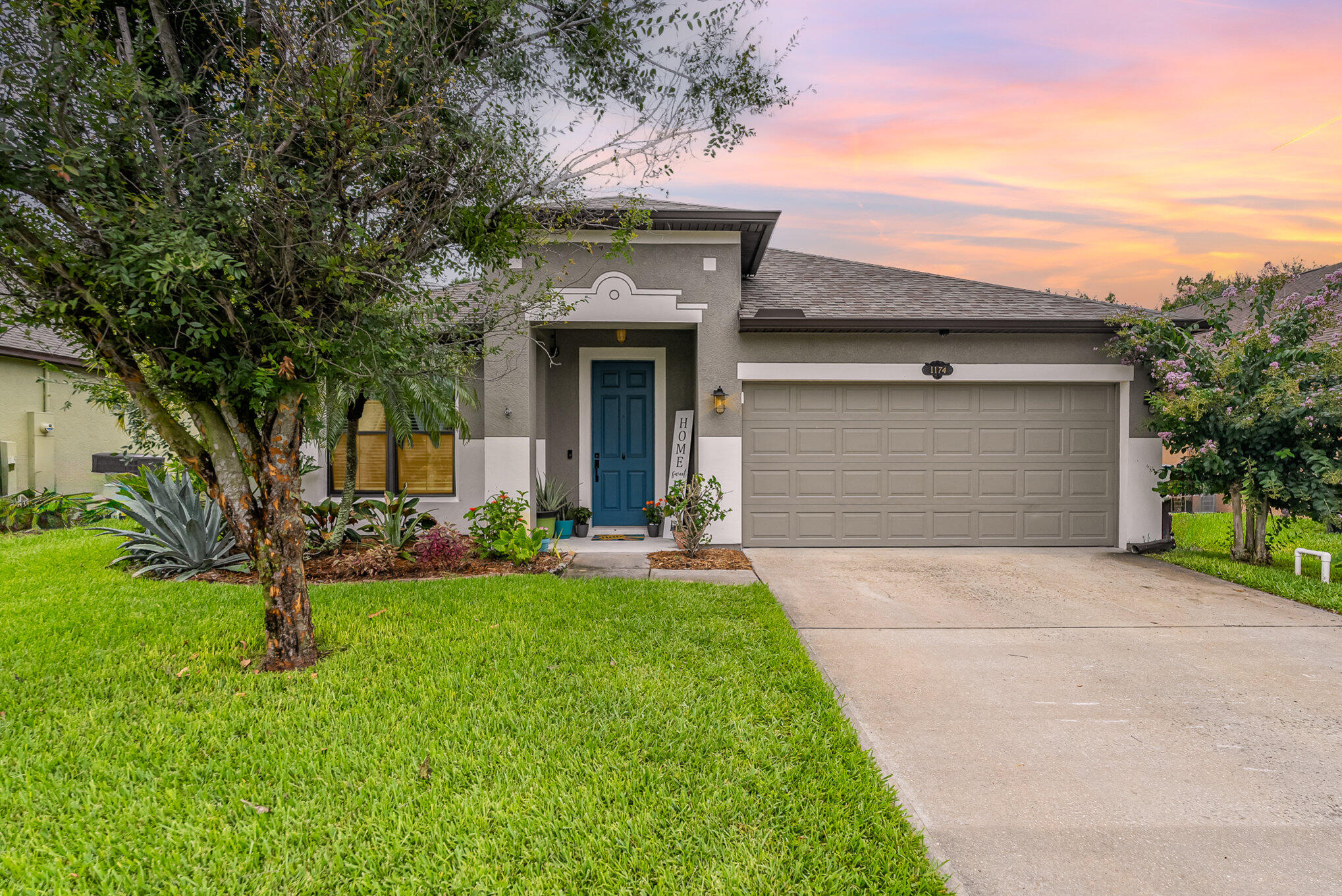 a front view of a house with a yard and garage