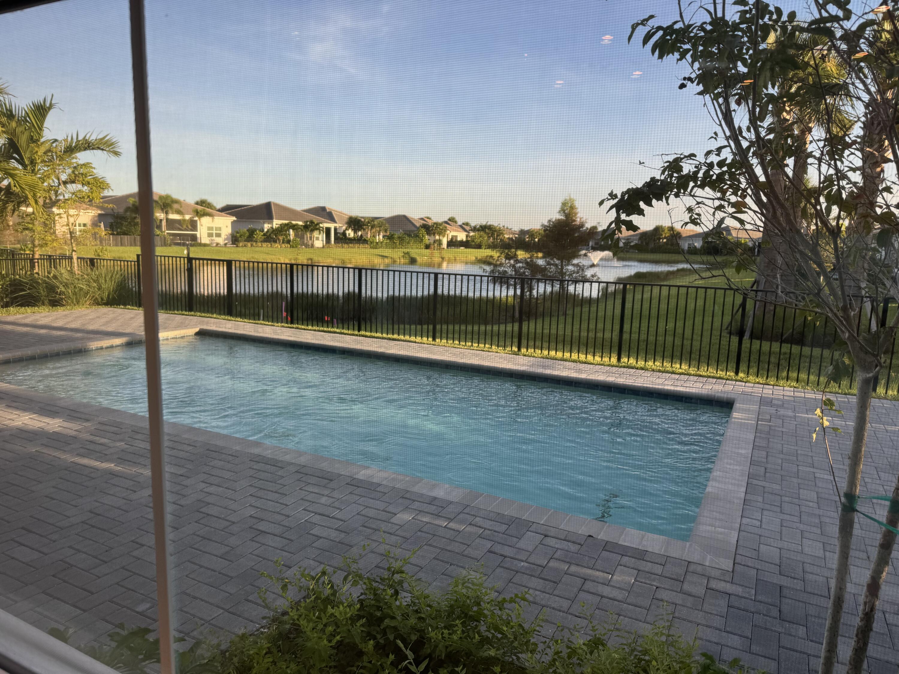 a view of a swimming pool with a lawn chairs