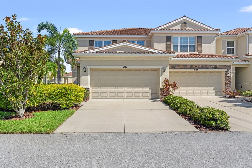 a front view of a house with a yard and garage