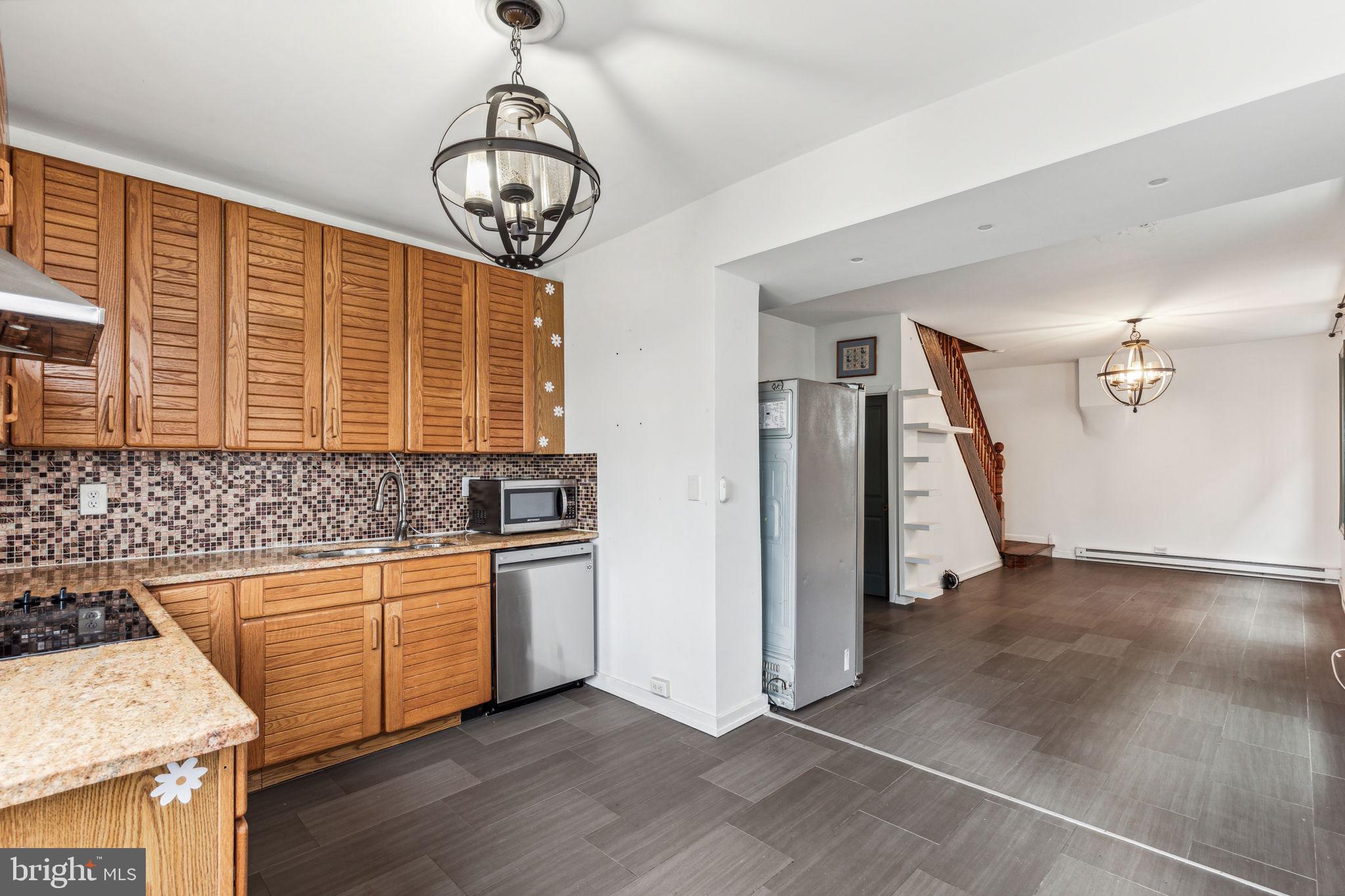 a kitchen with stainless steel appliances granite countertop a stove and a sink