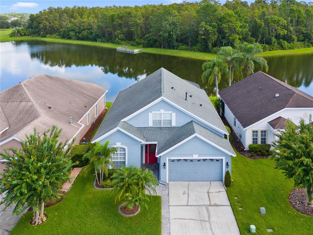 an aerial view of a house with a yard and a fountain