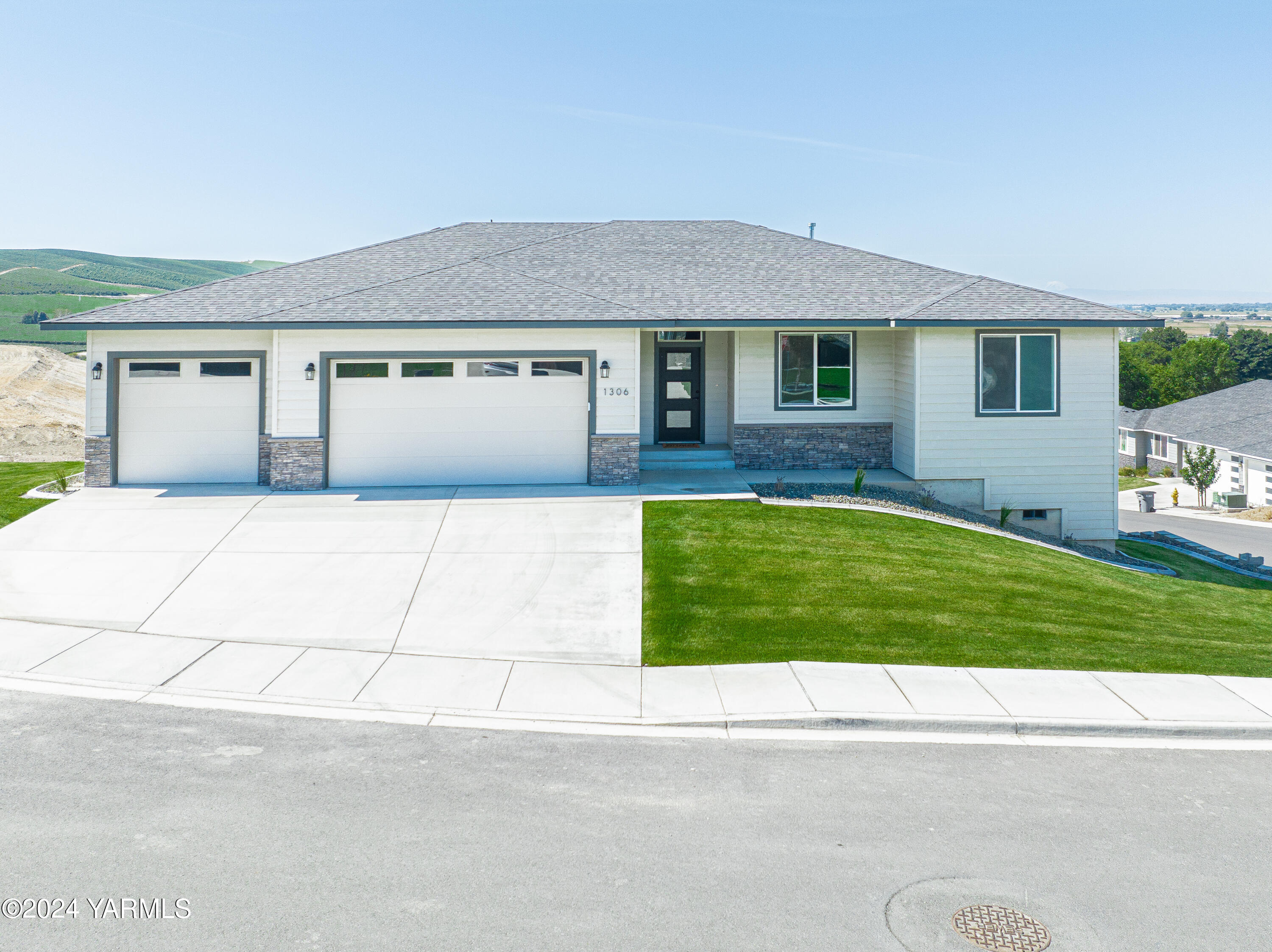 a front view of house with yard and outdoor seating