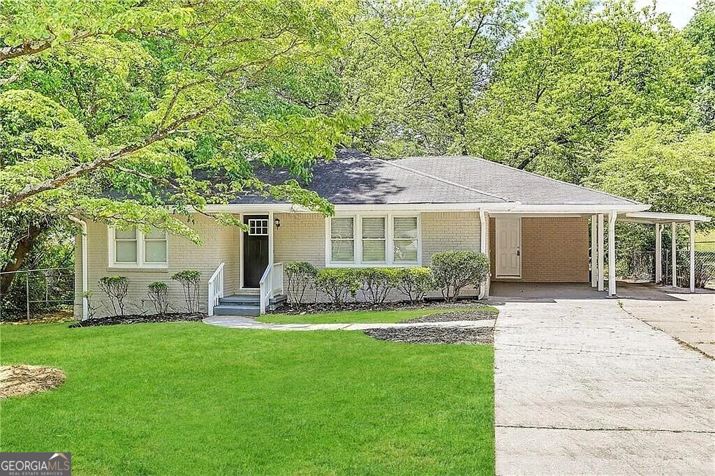 a front view of house with a garden and patio