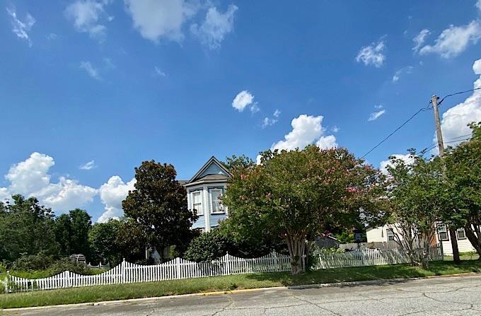 a view of a house with a yard and garage