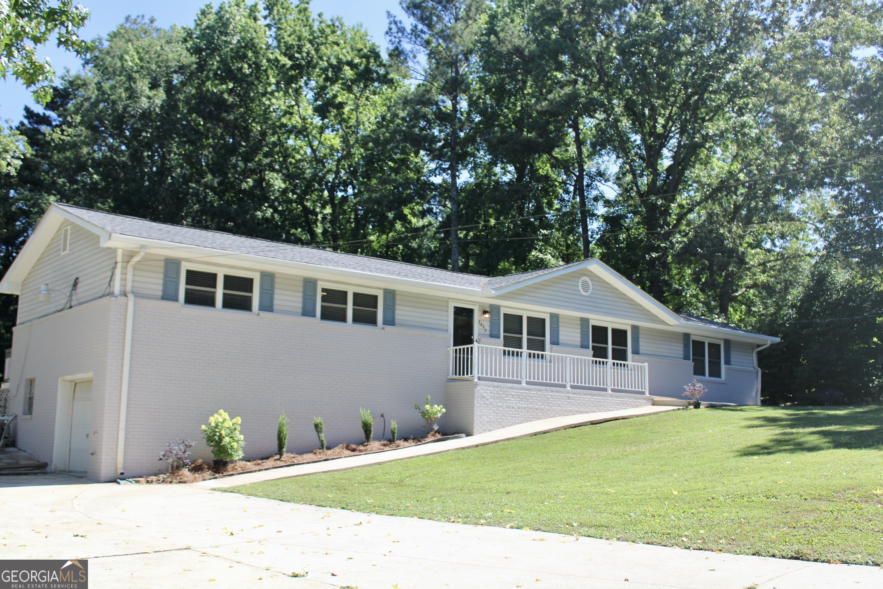 a front view of a house with a garden