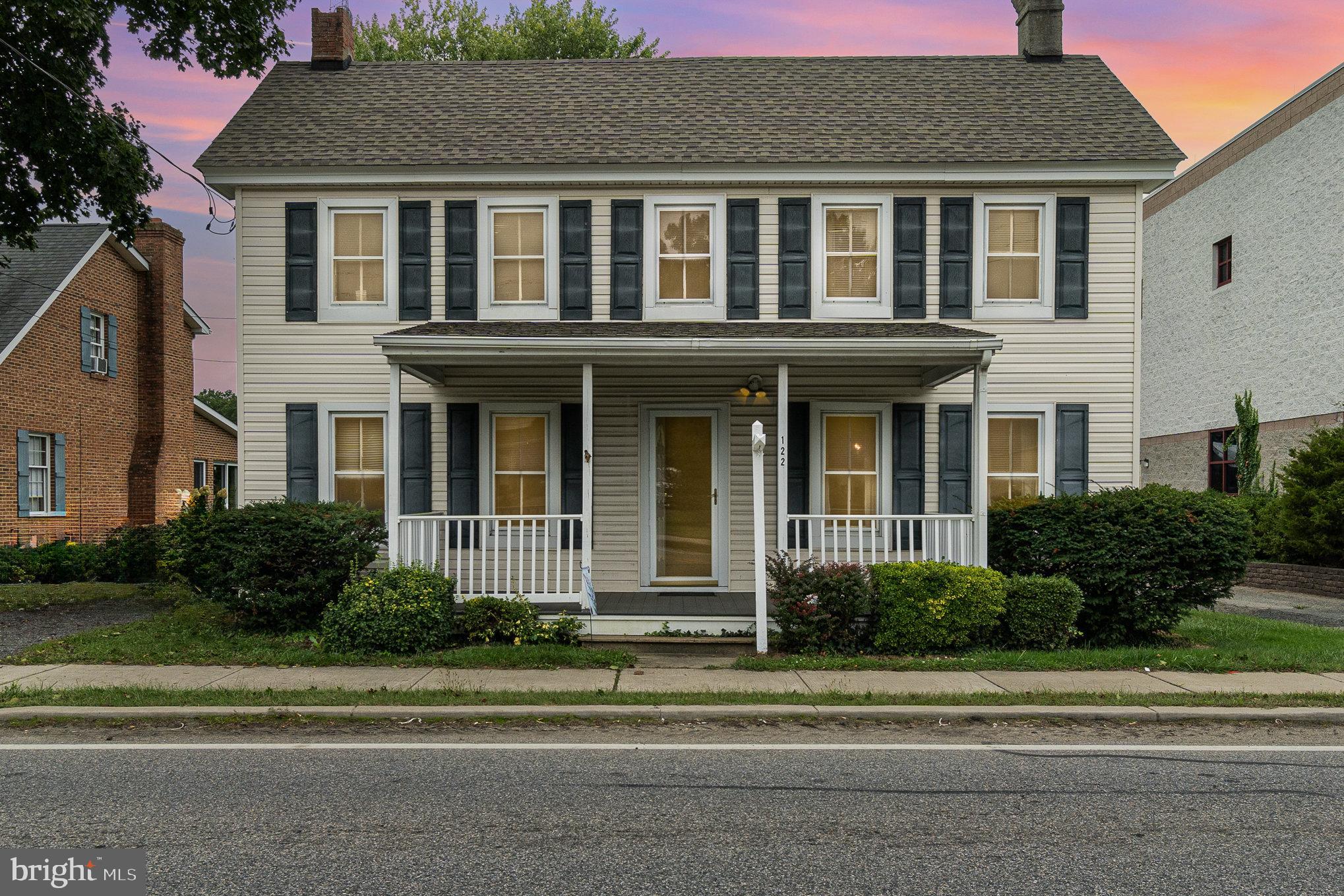 a front view of a house with a garden