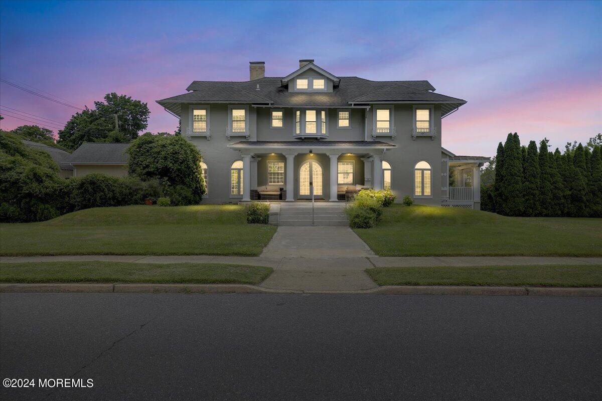 a front view of a house with a garden