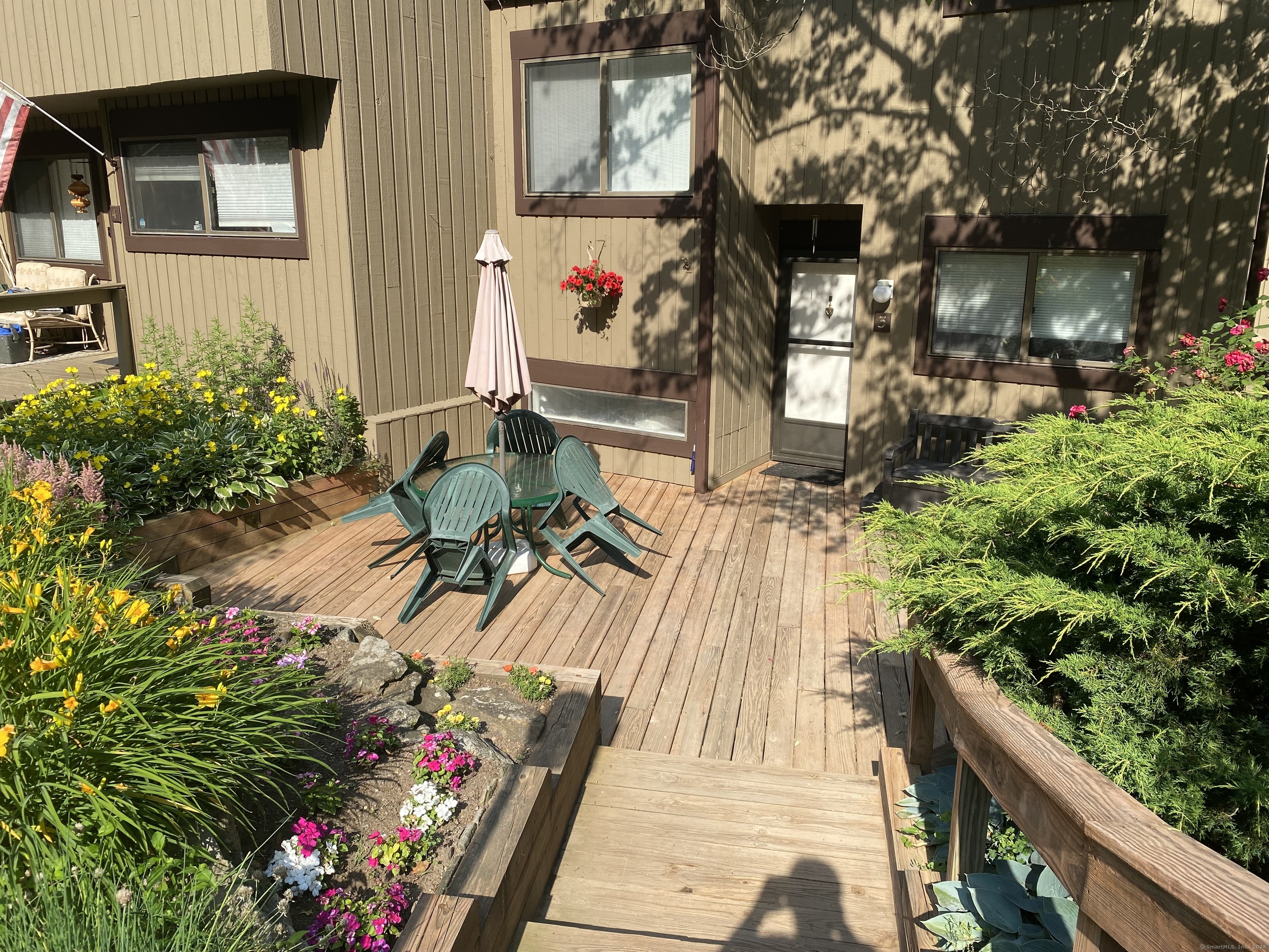 a view of a patio with table and chairs and potted plants