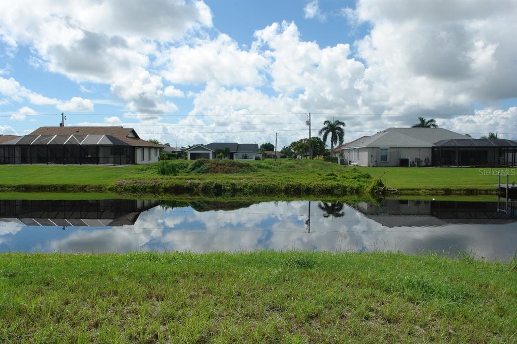 a view of a lake with a house in the background