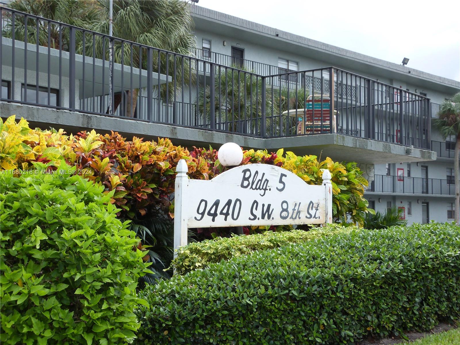 a view of sign board with wooden fence