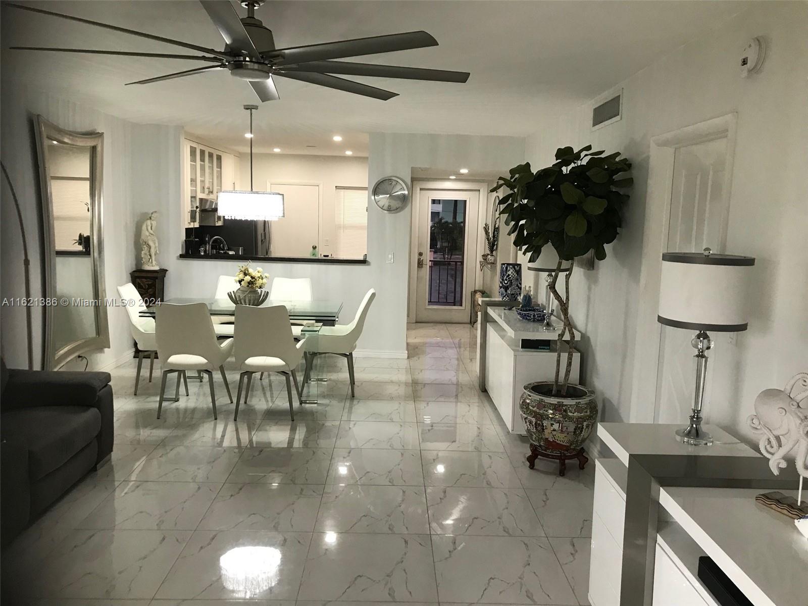 a dining room with furniture and a chandelier