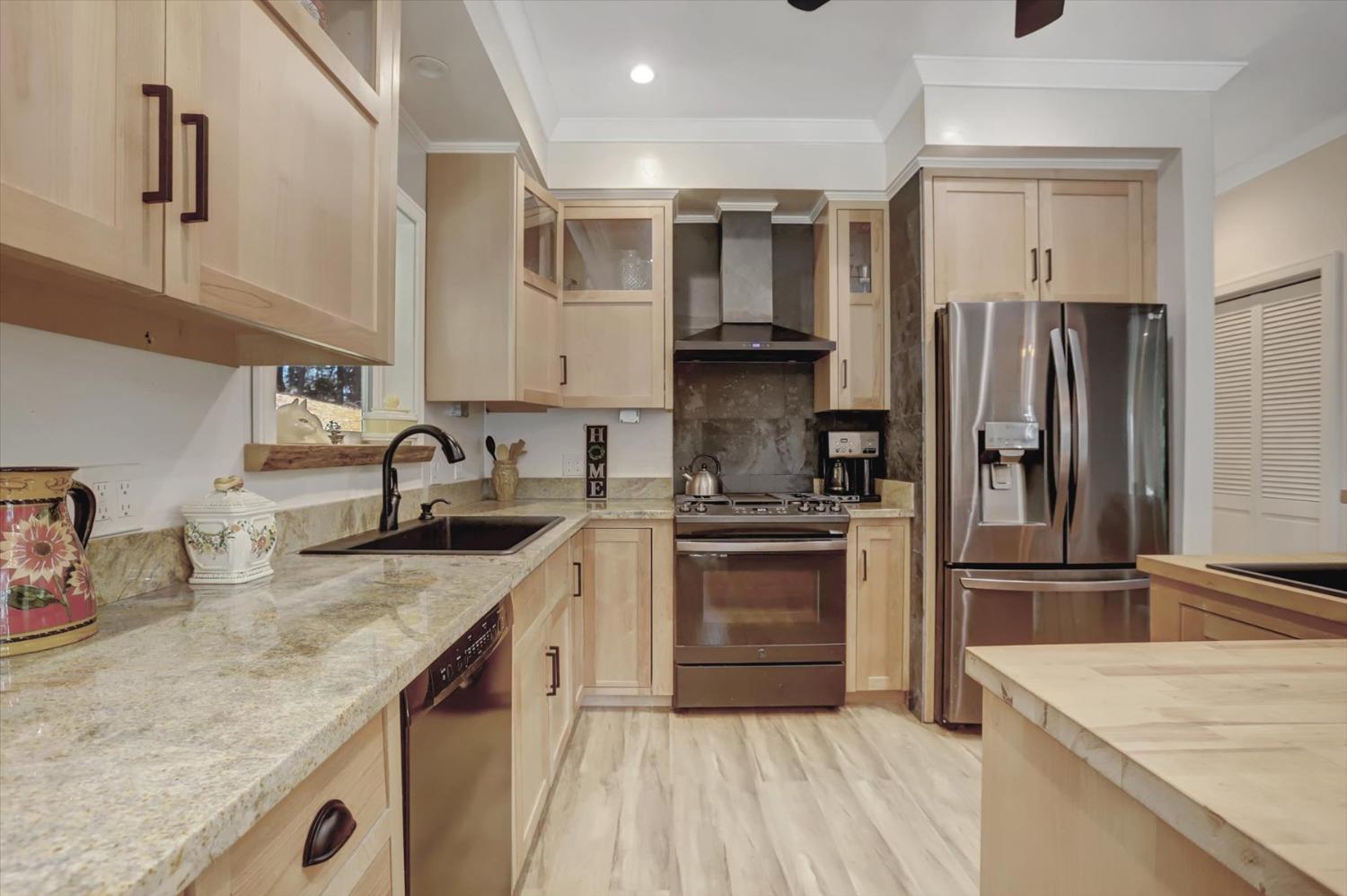 a kitchen with a sink stove and refrigerator