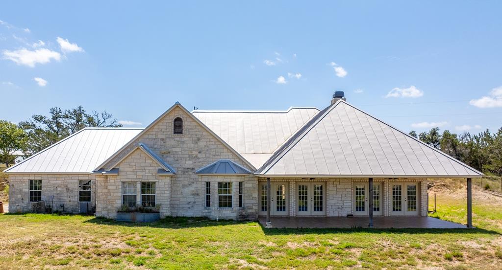 a front view of a house with a yard patio and swimming pool