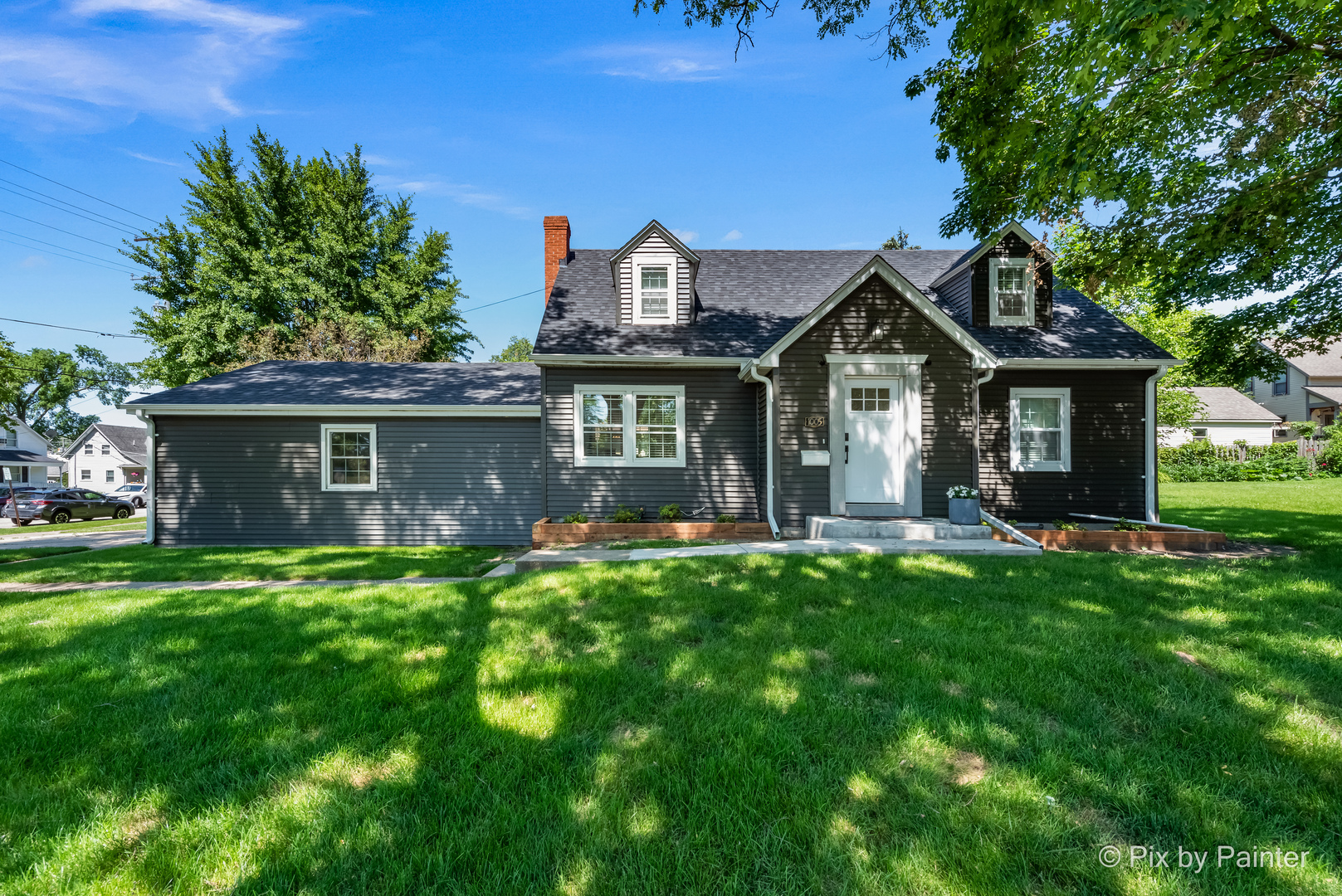 a front view of a house with a garden