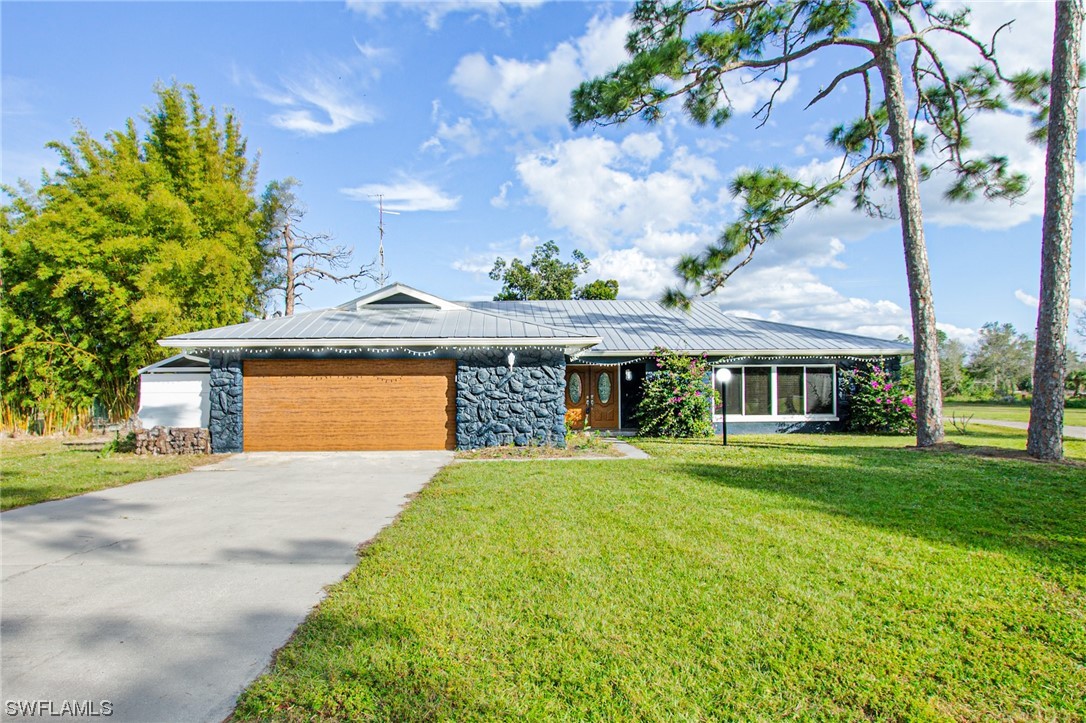 a front view of house with yard and green space