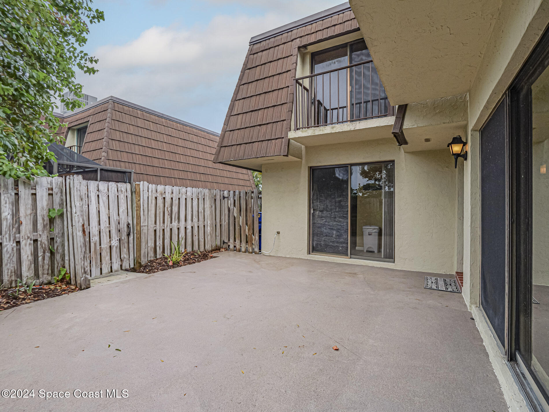 a view of a house with wooden fence