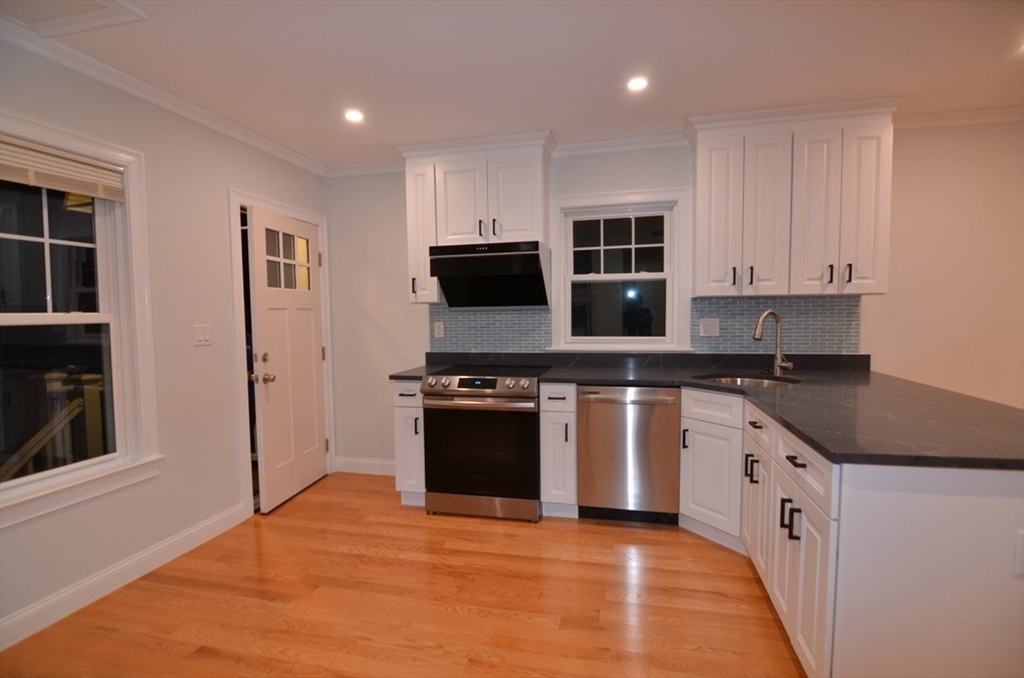 a kitchen with stainless steel appliances granite countertop a stove and a refrigerator