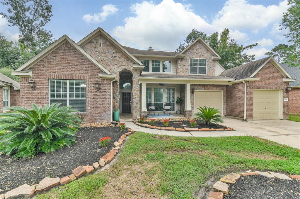 Landscaped front yard with stone accent borders, large front porch and 3 car garage.