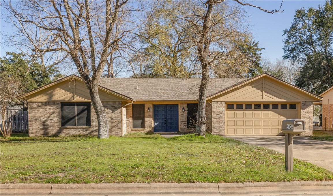 Ranch-style house with a front yard and a garage