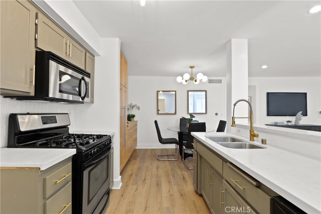 a kitchen with a refrigerator and a stove top oven