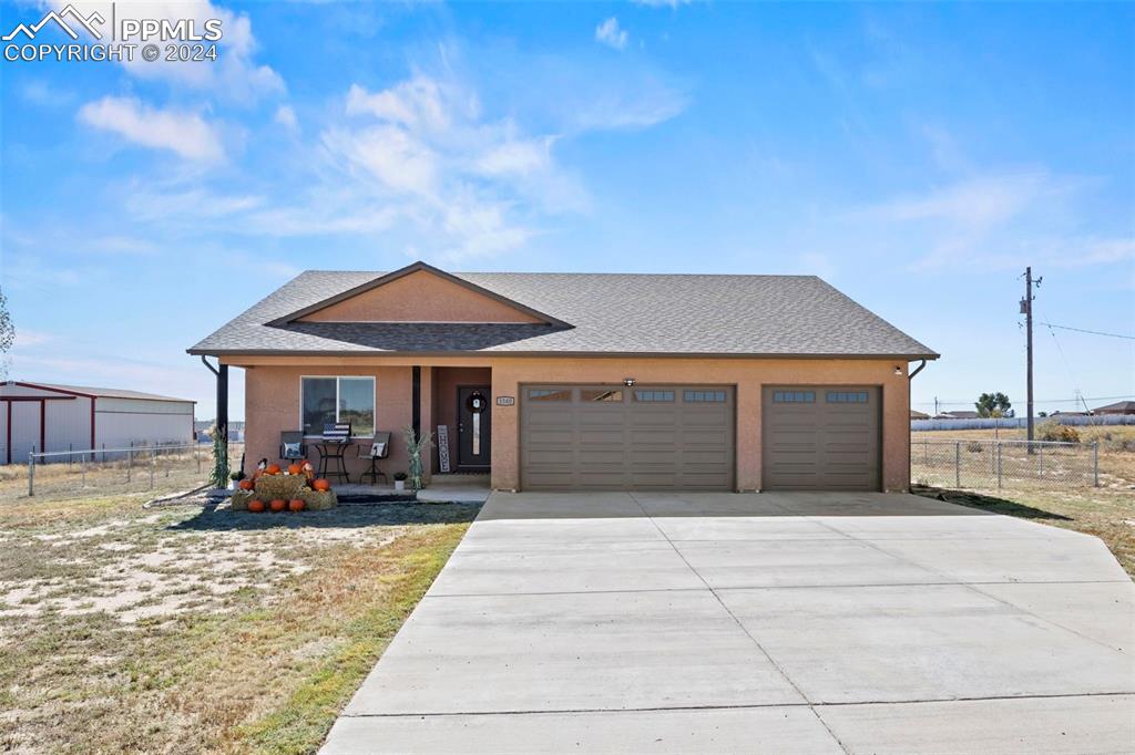 a front view of house with yard outdoor seating and barbeque oven