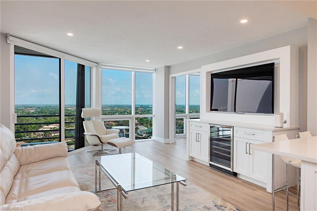 a living room with fireplace furniture and a large window