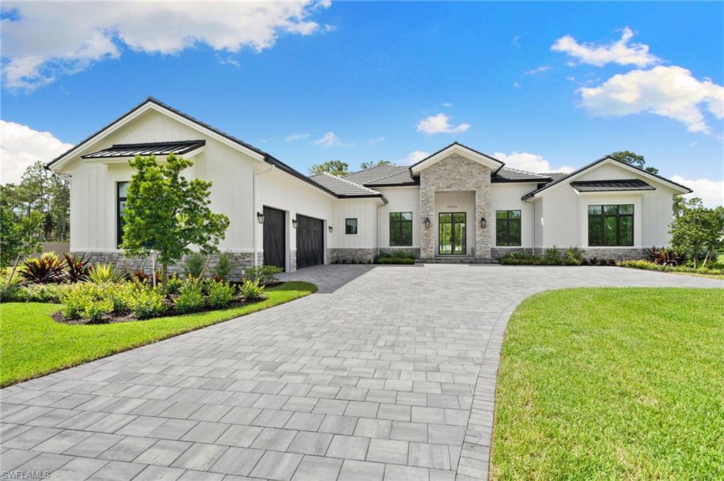 Modern farmhouse style home with a garage and a front yard