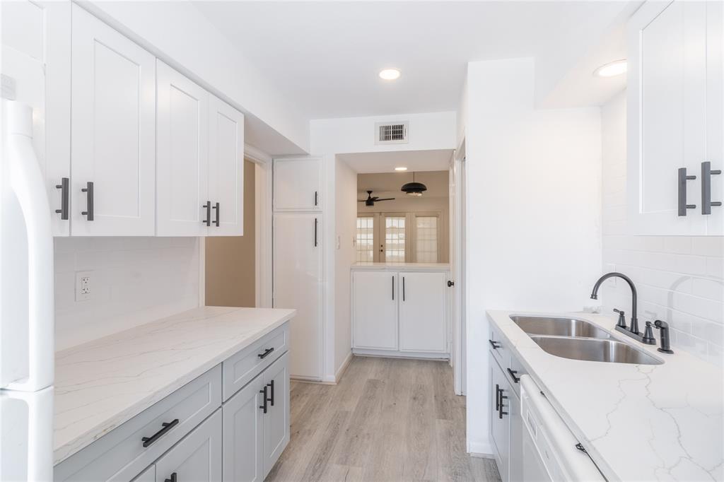 a kitchen with a sink and cabinets