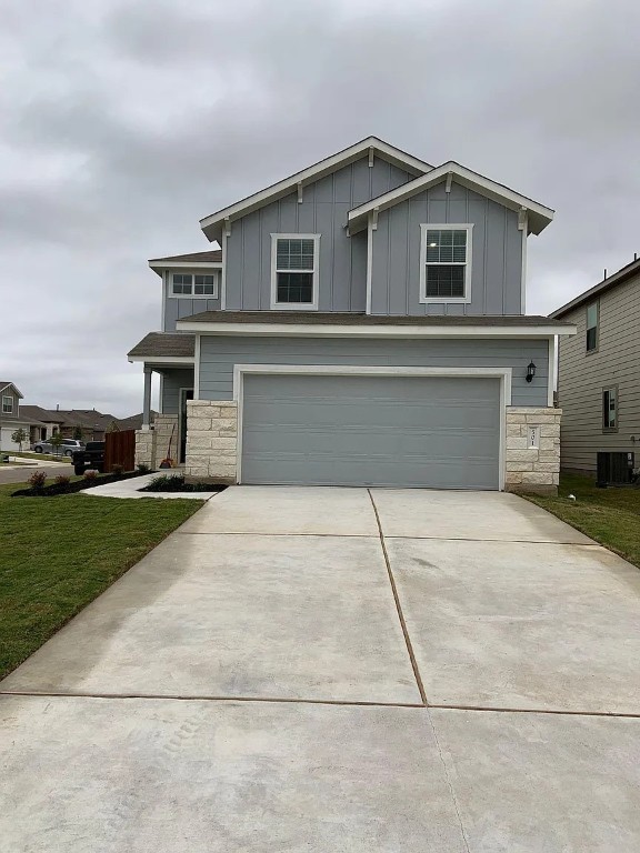 a front view of a house with a yard and a garage