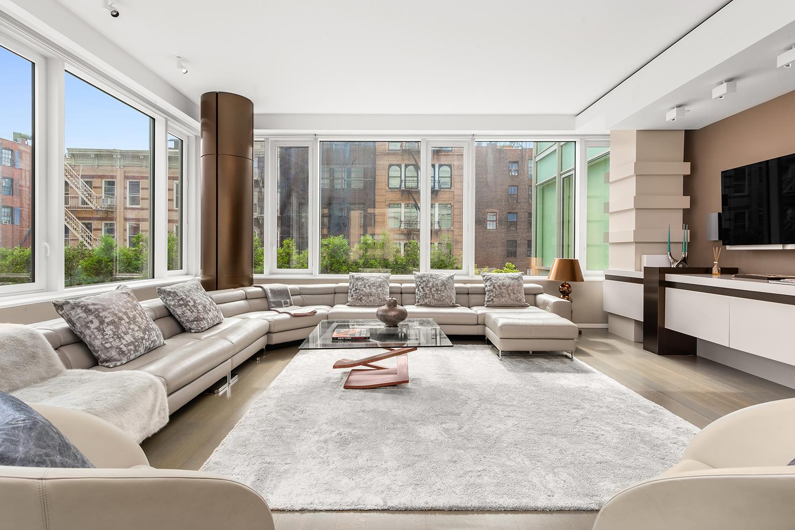 a living room with furniture and large windows