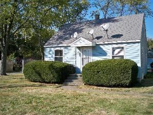 front view of a house with a large window