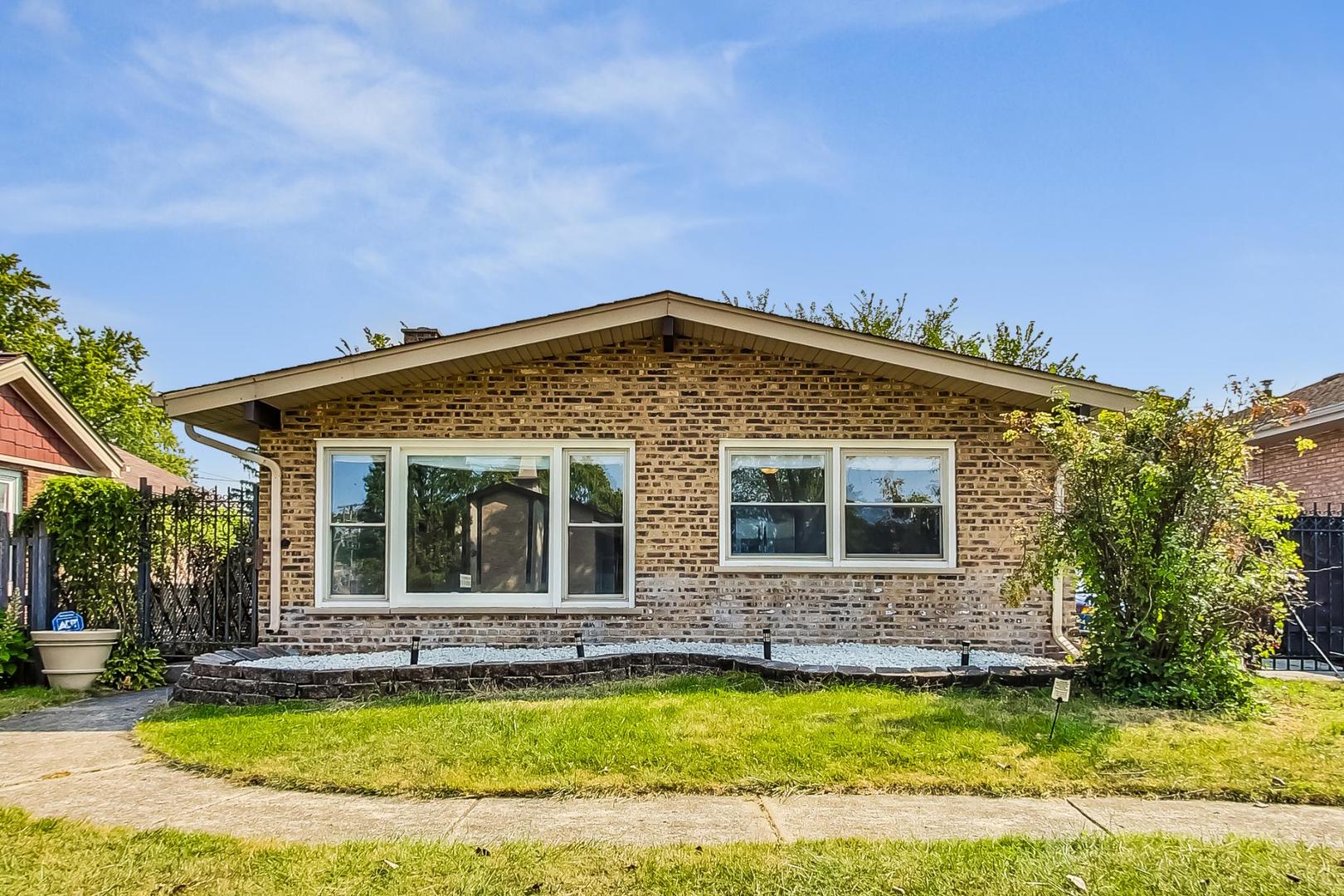 a view of a house with a swimming pool and a yard