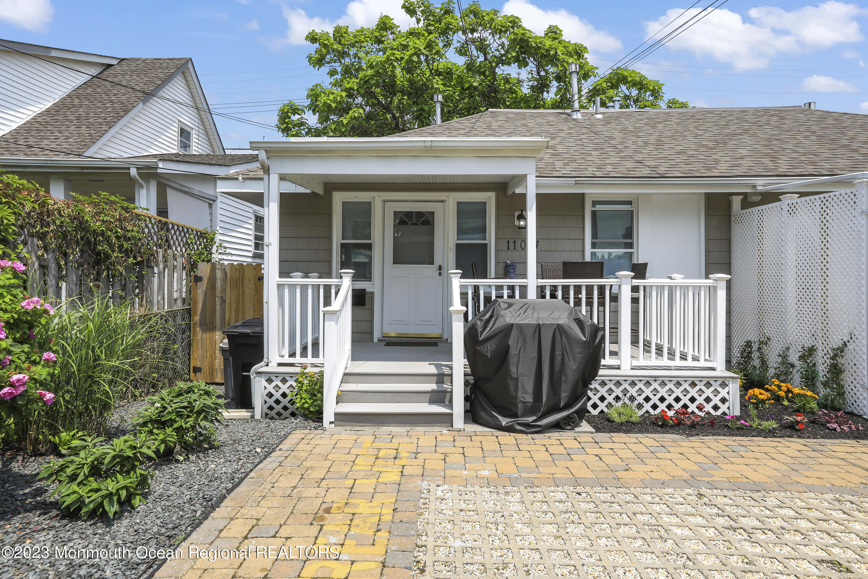 a view of a house with a small yard and flower plants