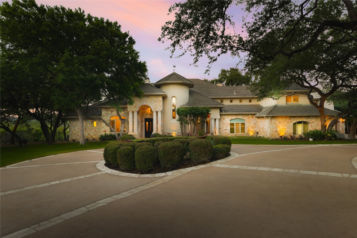 a front view of a house with a garden