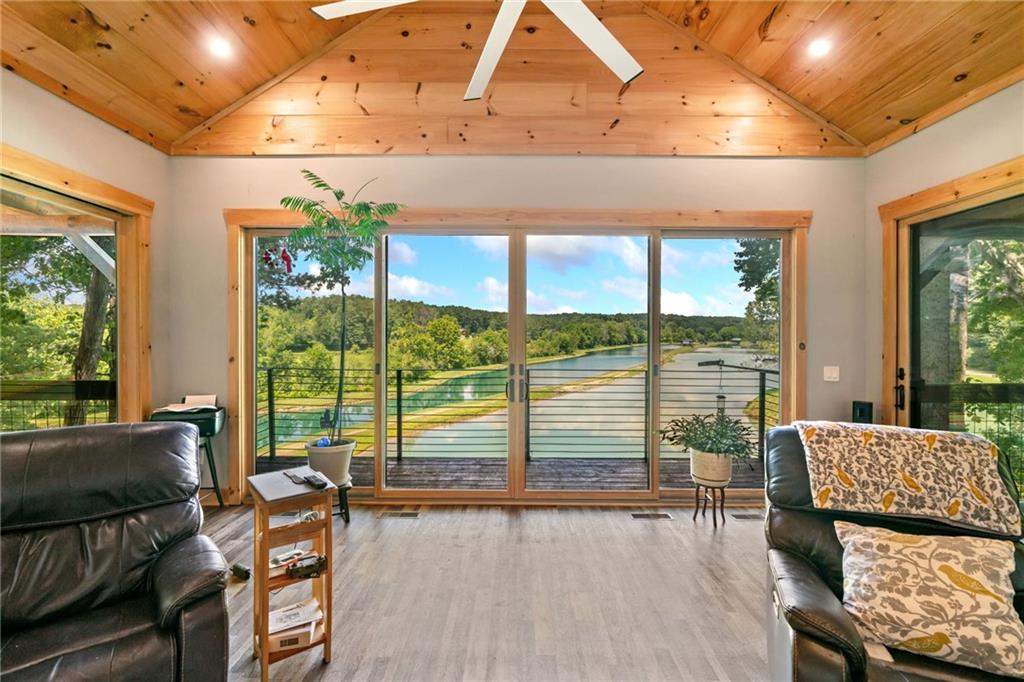 a living room with furniture and a floor to ceiling window