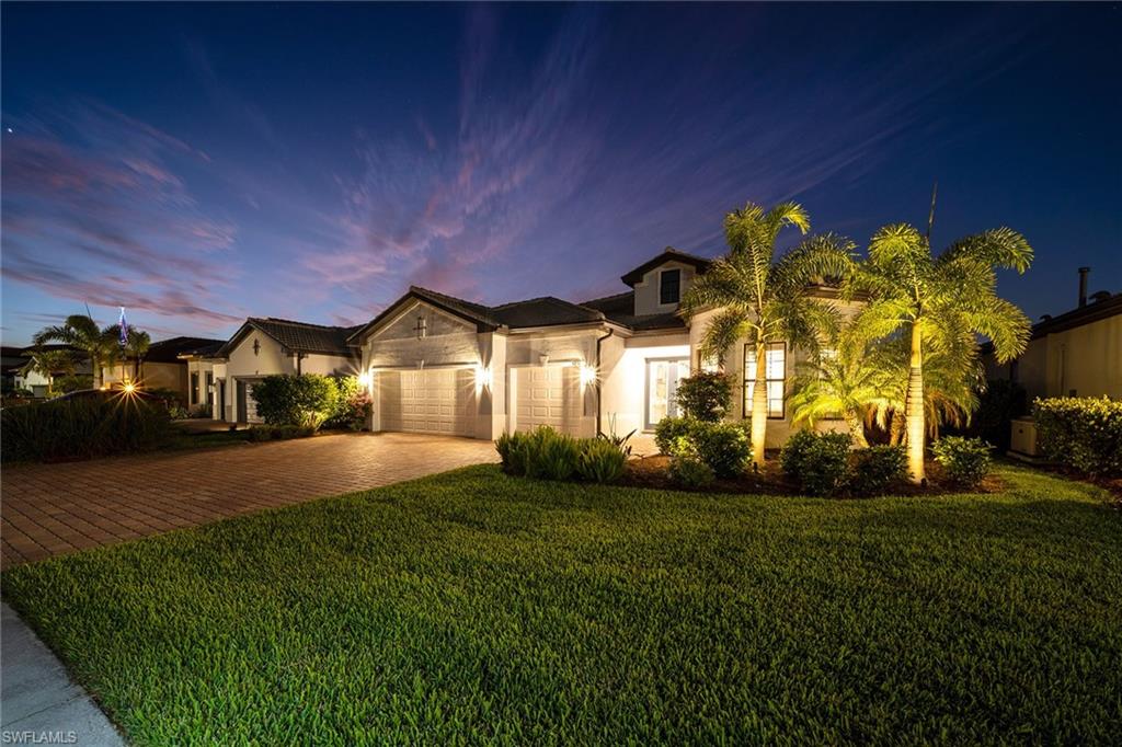 a front view of a house with a yard and garage