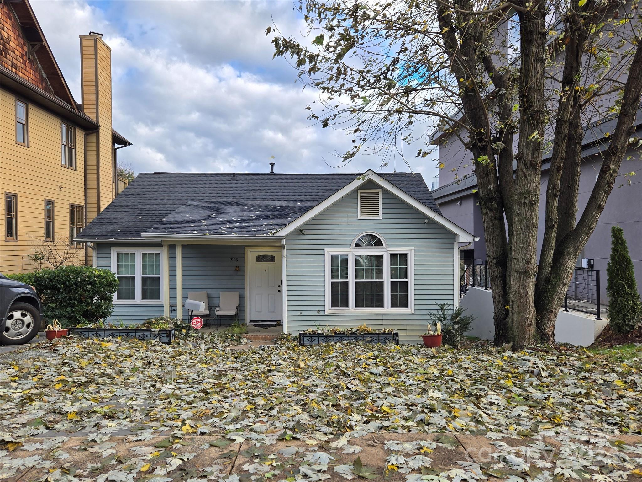 a front view of a house with a garden