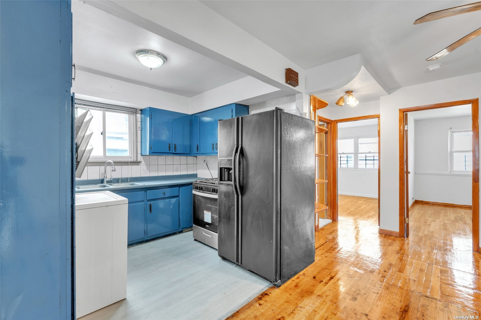 a kitchen with granite countertop a refrigerator and a sink