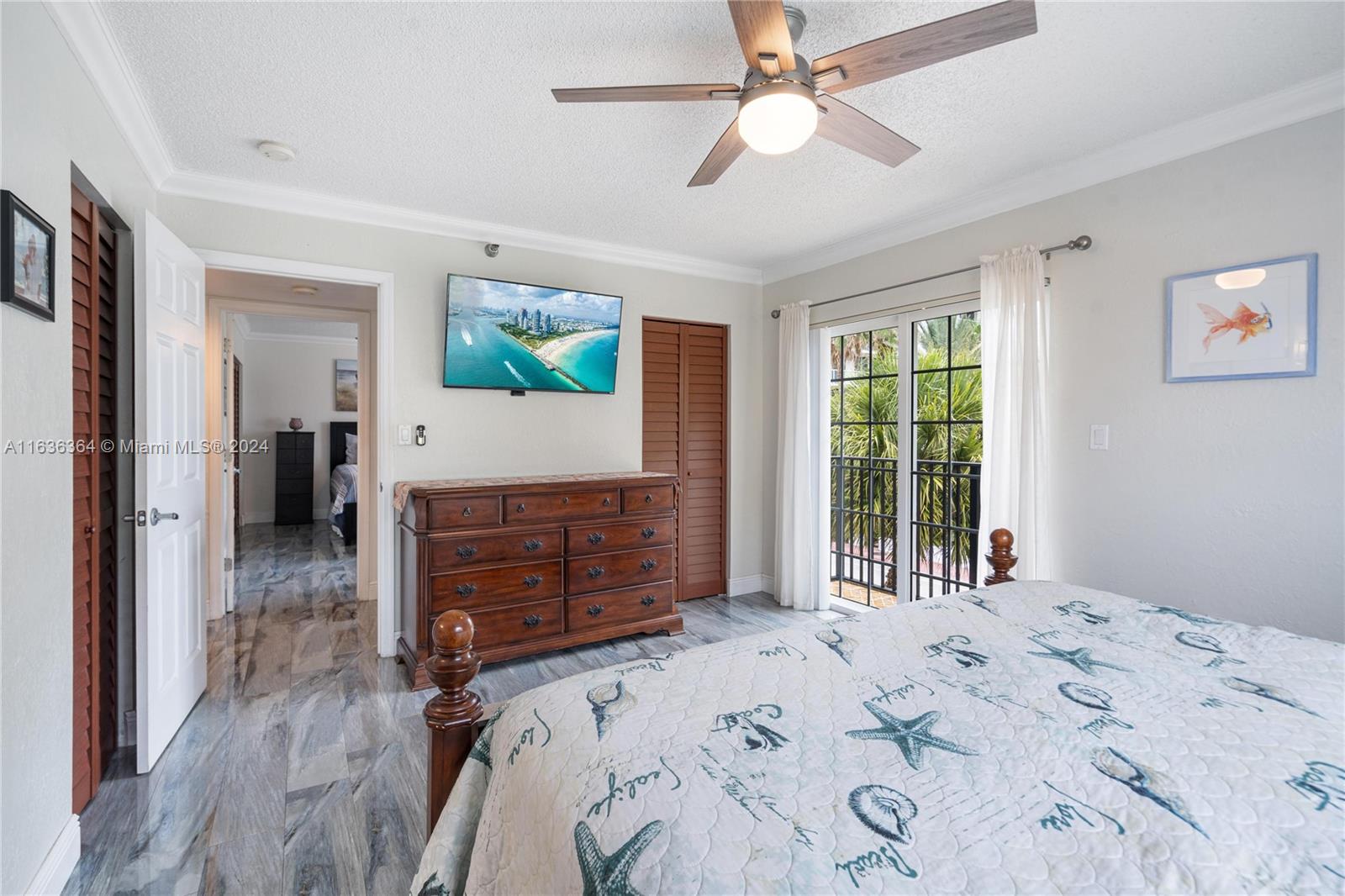 a bedroom with a bed dresser and a large window