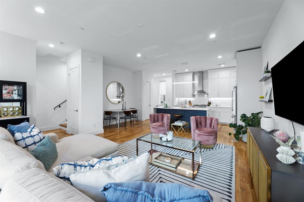 a living room with furniture a rug and a flat screen tv