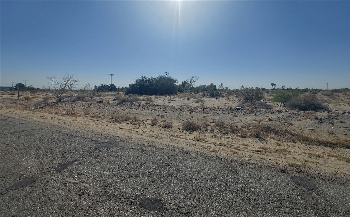 a view of dirt field and covered with trees