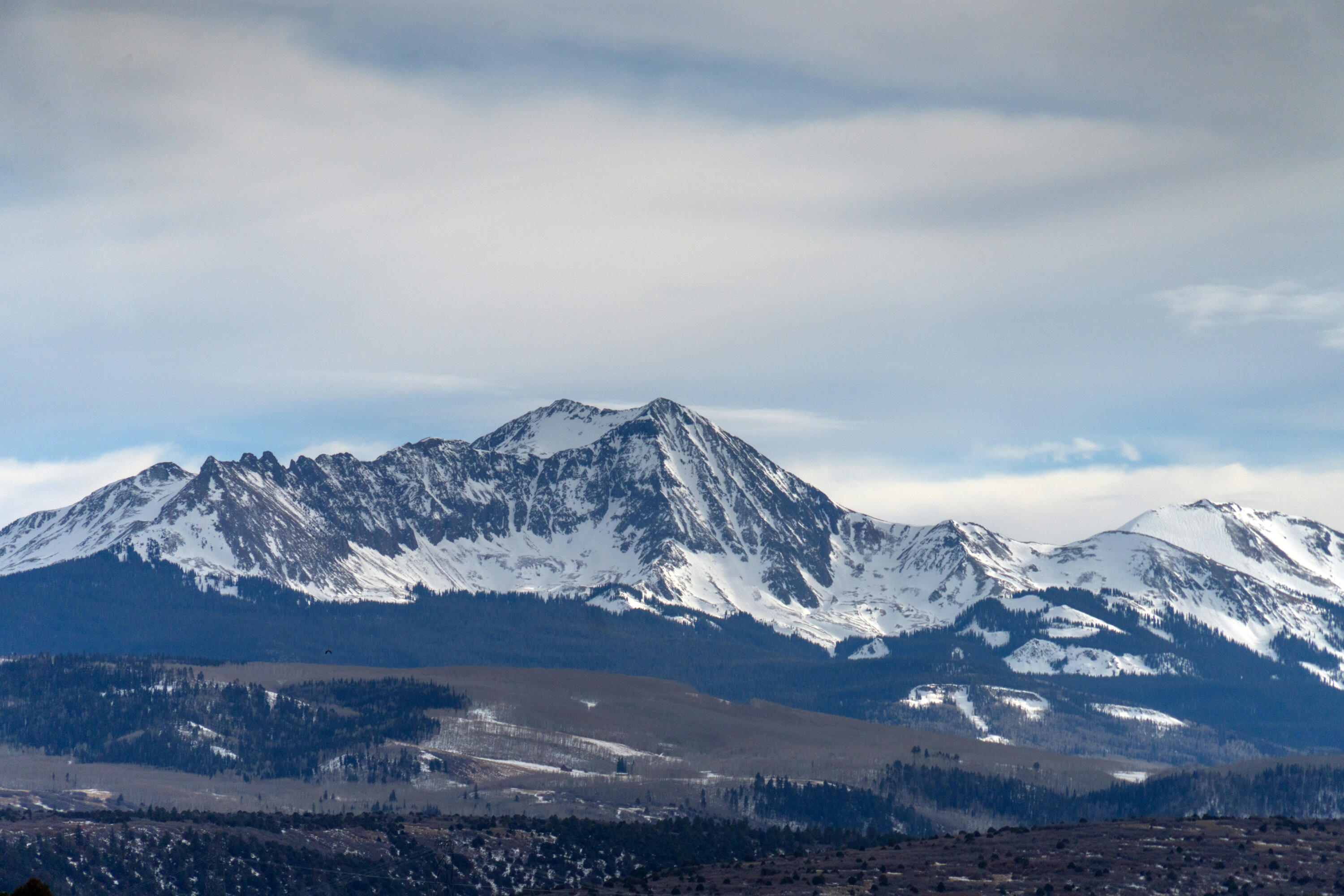 a view of mountain and with lots of trees in the background