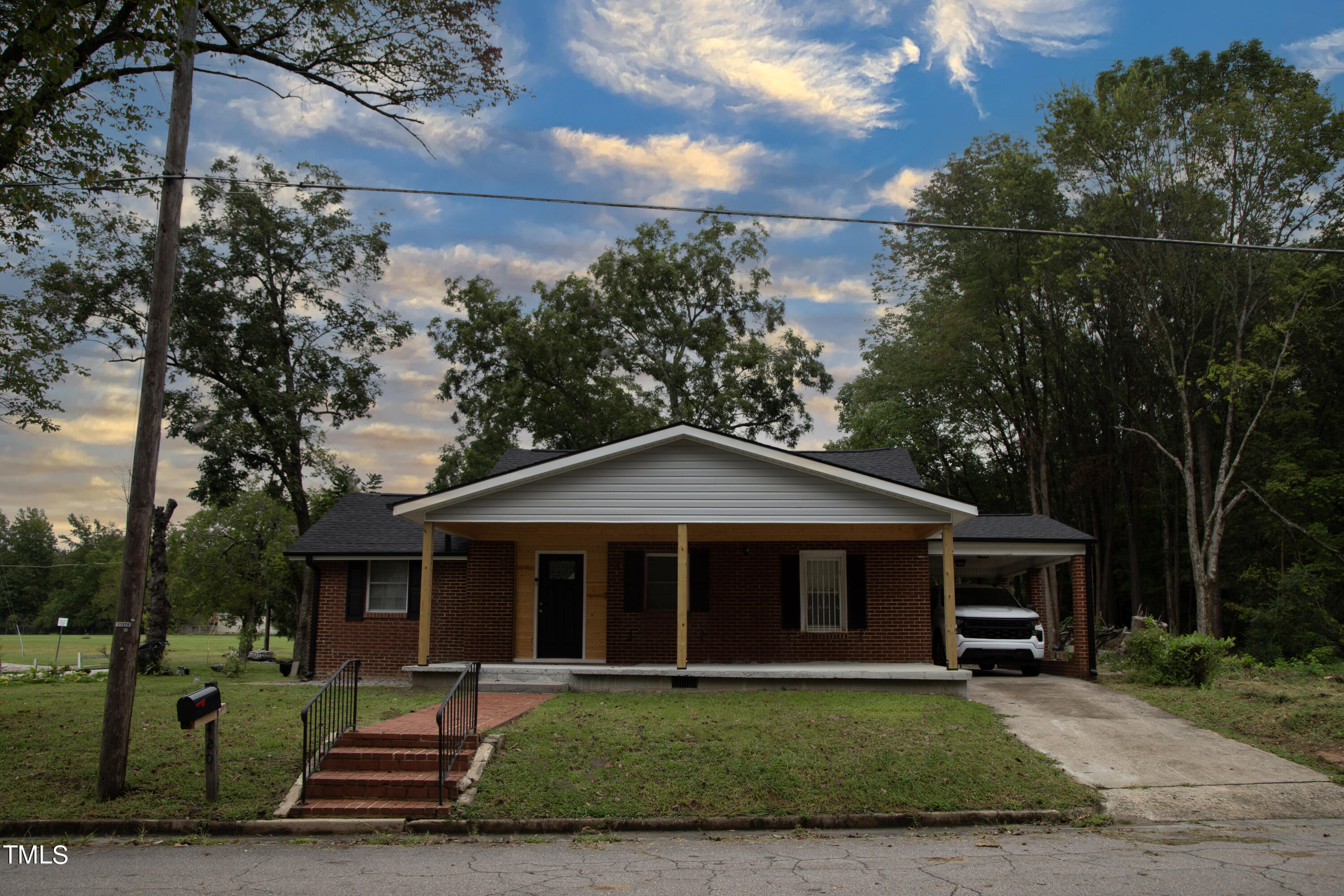 a front view of a house with a garden