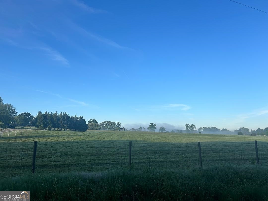 a view of grassy field with mountain