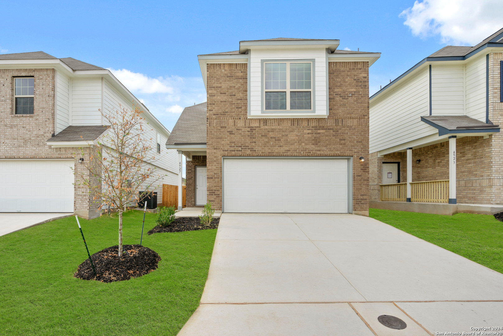 a front view of a house with a yard