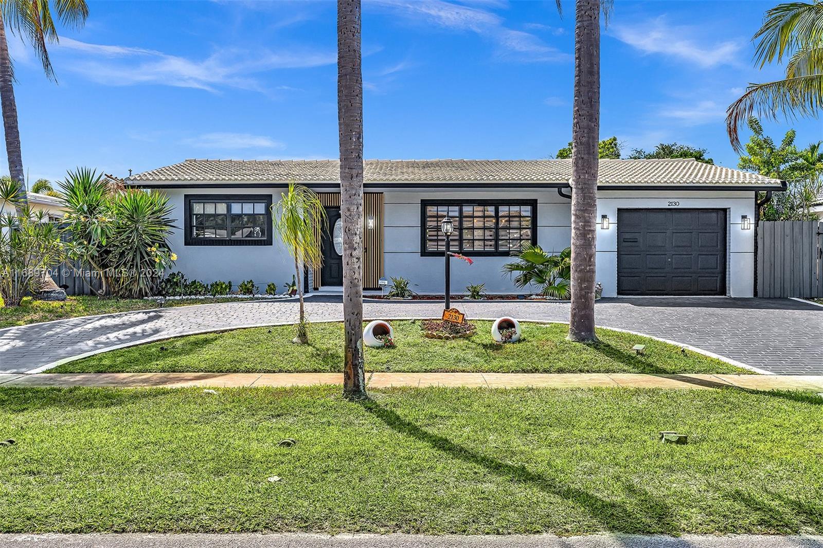 a view of a house with a yard and plants