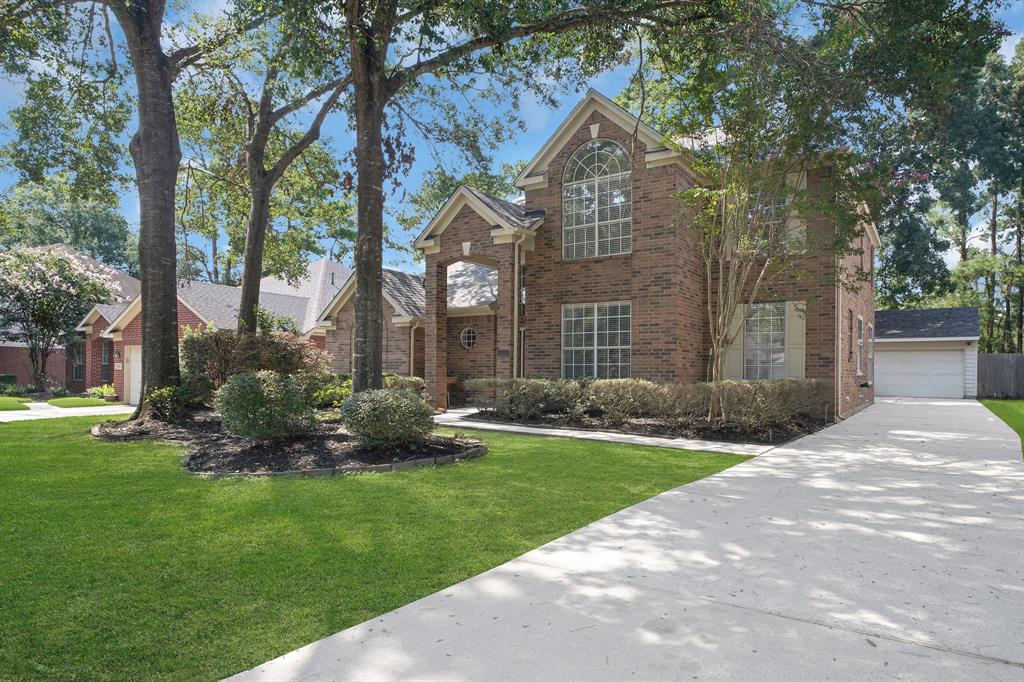 a view of a house with a yard and pathway