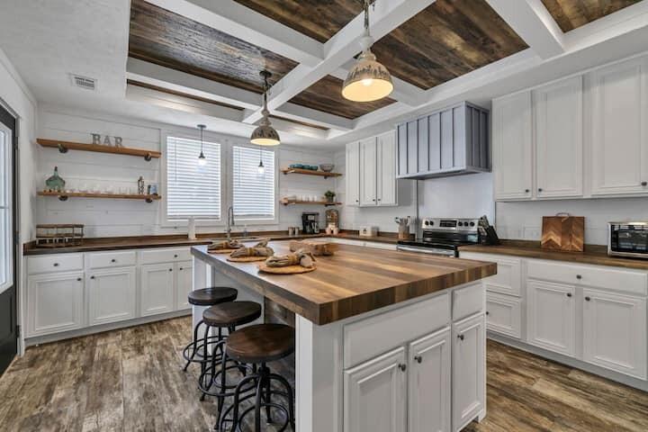 a kitchen with a stove sink cabinets and wooden floor