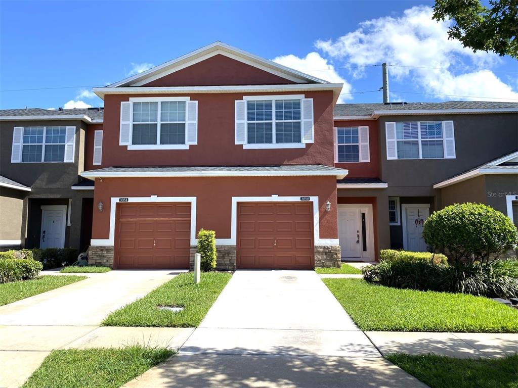 a front view of a house with a yard and garage