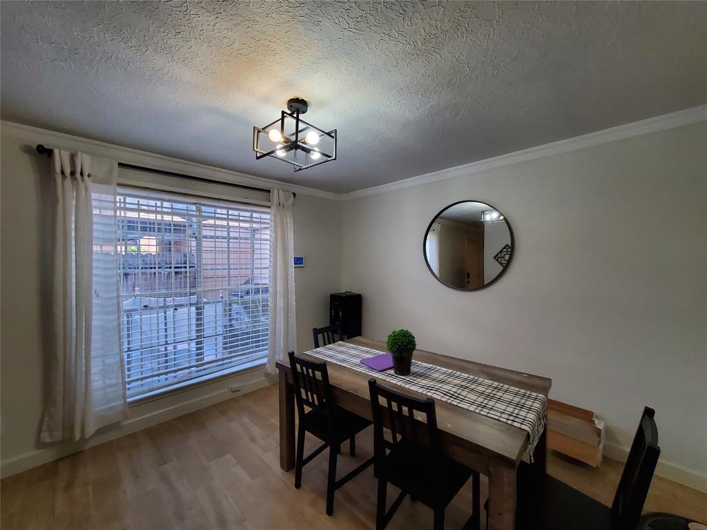 a view of a dining room with furniture wooden floor and chandelier